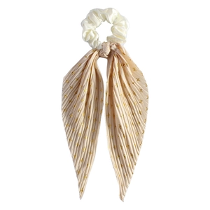 Close-up of cream silk scrunchie with pleated ribbon and gold dotted pattern detail