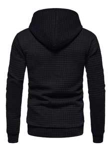 Macro shot of men's black hoodie featuring detailed waffle knit texture on the back panel