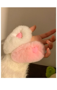 Detail of soft pink and white faux fur hair clips with cute pink heart embellishments