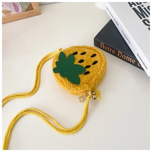 Detail of yellow plush kid's crossbody bag with green leaf decor and floral metal zipper