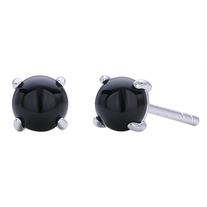 Macro shot of minimalist S925 silver stud earrings with black round stone in four-prong setting
