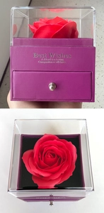 Detail of double-layer purple gift box with red rose and clear acrylic lid