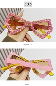 Detailed views of heart-shaped oversized sunglasses with pink rhinestones and yellow temples