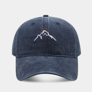 Navy washed cotton baseball cap featuring white snow mountain and orange sunset embroidery