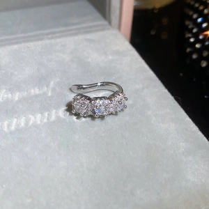 Macro view of geometric silver ear cuff featuring three sparkling round zircon stones