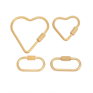 Detailed macro of gold heart and oval screw lock connectors for jewelry making