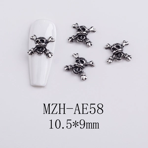 Macro view of vintage silver skull and crossbones nail charms, size 10.5x9mm