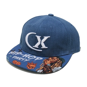 Detailed view of dark blue denim flat brim cap with 3D CX embroidery and hip-hop prints
