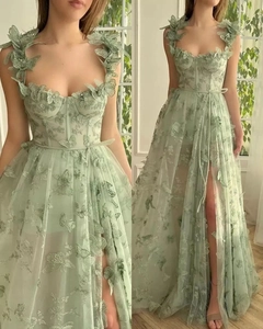 Detailed view of mint green tulle bridal gown with 3D butterfly appliques and high slit