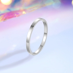 S925 sterling silver minimalist ring showing glossy finish and inner stamp on blurry bokeh
