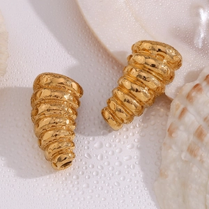 Detail of 18K gold-plated stainless steel stud earrings with golden conch shell spiral design