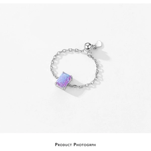 Detailed macro view of S925 sterling silver chain ring with opal stone and adjustment heart