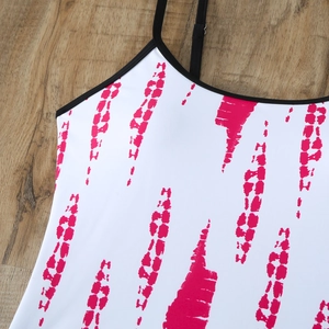 Close-up detail of tankini top with pink brushstroke print and black shoulder straps