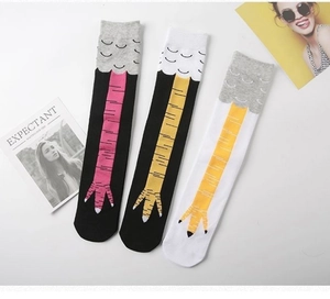 Flat lay of creative chicken leg pattern mid-calf socks in three color combinations