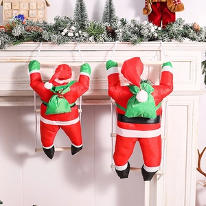 Detail of Christmas Santa climbing ropes on white fireplace with pine cone decorations
