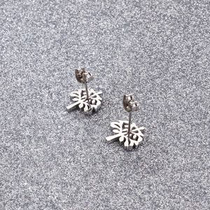 Polished stainless steel Tree of Life stud earrings on a sparkling silver background