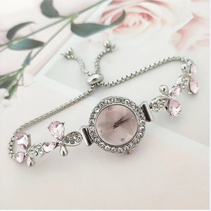Detailed view of silver flower bracelet watch with pink dial and adjustable slider clasp