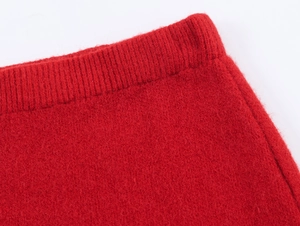 Detailed close-up of vibrant red knit fabric with high-quality ribbed hem textures