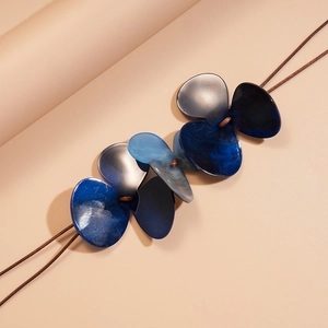 Detail of acrylic floral charms with marble texture on double-layer wax cord necklace