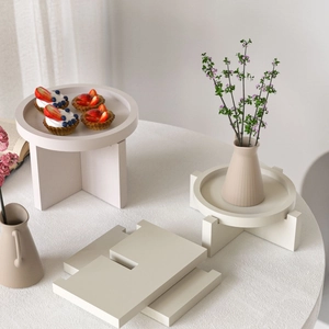 Minimalist cream round tray with geometric pedestal stand for dessert display and home decor