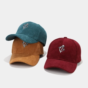 Corduroy baseball caps with mushroom embroidery in blue, yellow, and red colors