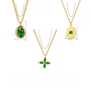 Detailed view of three 18K gold plated necklaces featuring emerald zircon and crystal