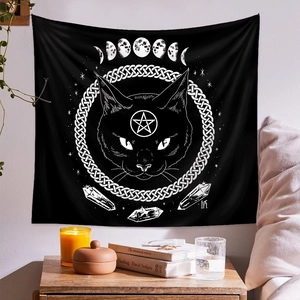 Detail of occult cat tapestry with crescent moon phases and celtic knots on bedroom wall