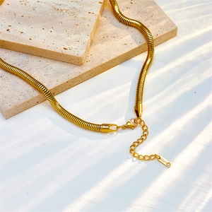 Elegant gold snake chain necklace in stainless steel with lobster clasp on stone