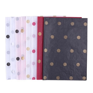 Golden polka dot tissue paper sheets in black red and pink for floral gift packaging