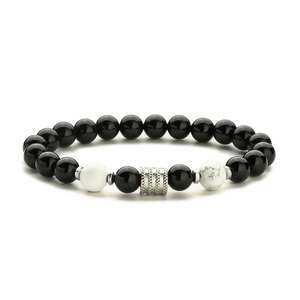 Detailed shot of black obsidian beads with silver spacers and natural stone accents