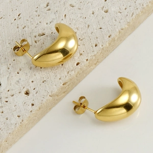 Detailed close-up of 18K gold-plated titanium steel hoop earrings on a stone base