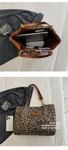Detail view of large leopard print tote bag interior with spacious storage and handles