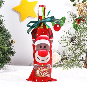 Detailed close-up of a festive red reindeer wine bottle cover with Warm Wishes sign