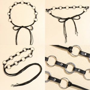 Detail of black leather waist chain with engraved silver metal rings and tassel ties