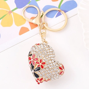 Detailed macro view of heart crystal keychain with rhinestones and floral drip oil pattern