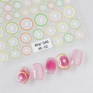 Adhesive citrus nail art stickers with lemon and orange slices on gradient pink nails