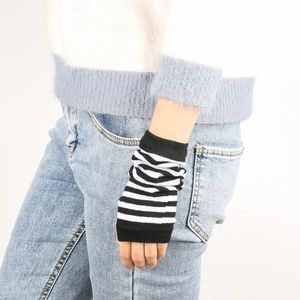 Close-up of black and white striped knitted fingerless gloves with a soft texture