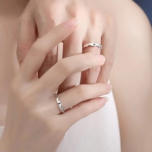 Minimalist silver couple rings with mountain ridge design and black gemstone inlay