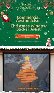 Macro view of orange graffiti Christmas tree UV sticker with Merry Christmas text on glass