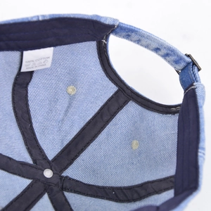 Detail of washed denim baseball cap interior with cotton sweatband and adjustable buckle
