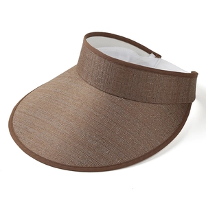 Close-up of woven straw sun visor texture with soft brown fabric edging and sweatband