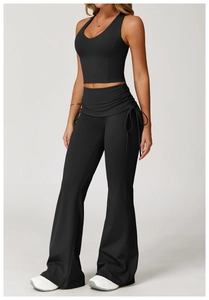 Women's black yoga set featuring high-waist flared pants with side drawstring details