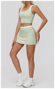 Detail of light green ribbed yoga set featuring white contrast trim on the tank top neckline