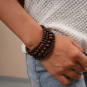 Detailed close-up of multilayer dark brown coconut wood bead bracelet on a wrist