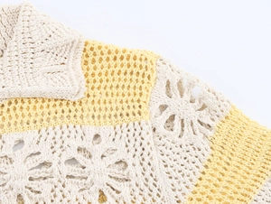 Detailed macro of floral cutout crochet stitching and off-white knit mesh texture