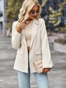 Close-up of beige short-sleeved blazer featuring professional tailored design and sharp fit