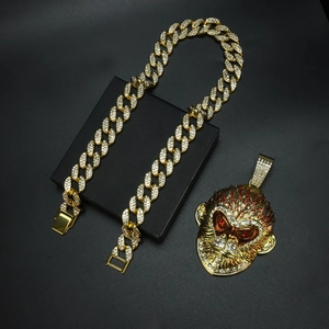 Macro shot of hip hop style iced out gold monkey pendant with red and clear rhinestones
