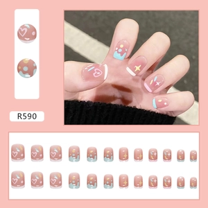 Cute colorful press-on nails with pink blush base, blue French tips, and heart star patterns