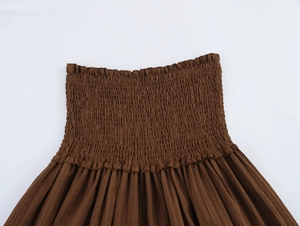 Detail of brown beach set featuring elastic smocked fabric and textured pleats