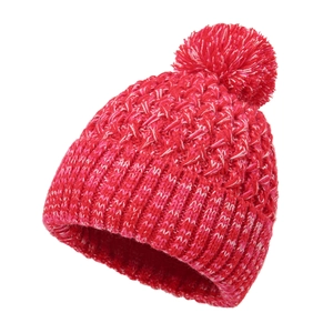 Close-up of red and white knitted winter beanie with chunky texture and soft pom-pom